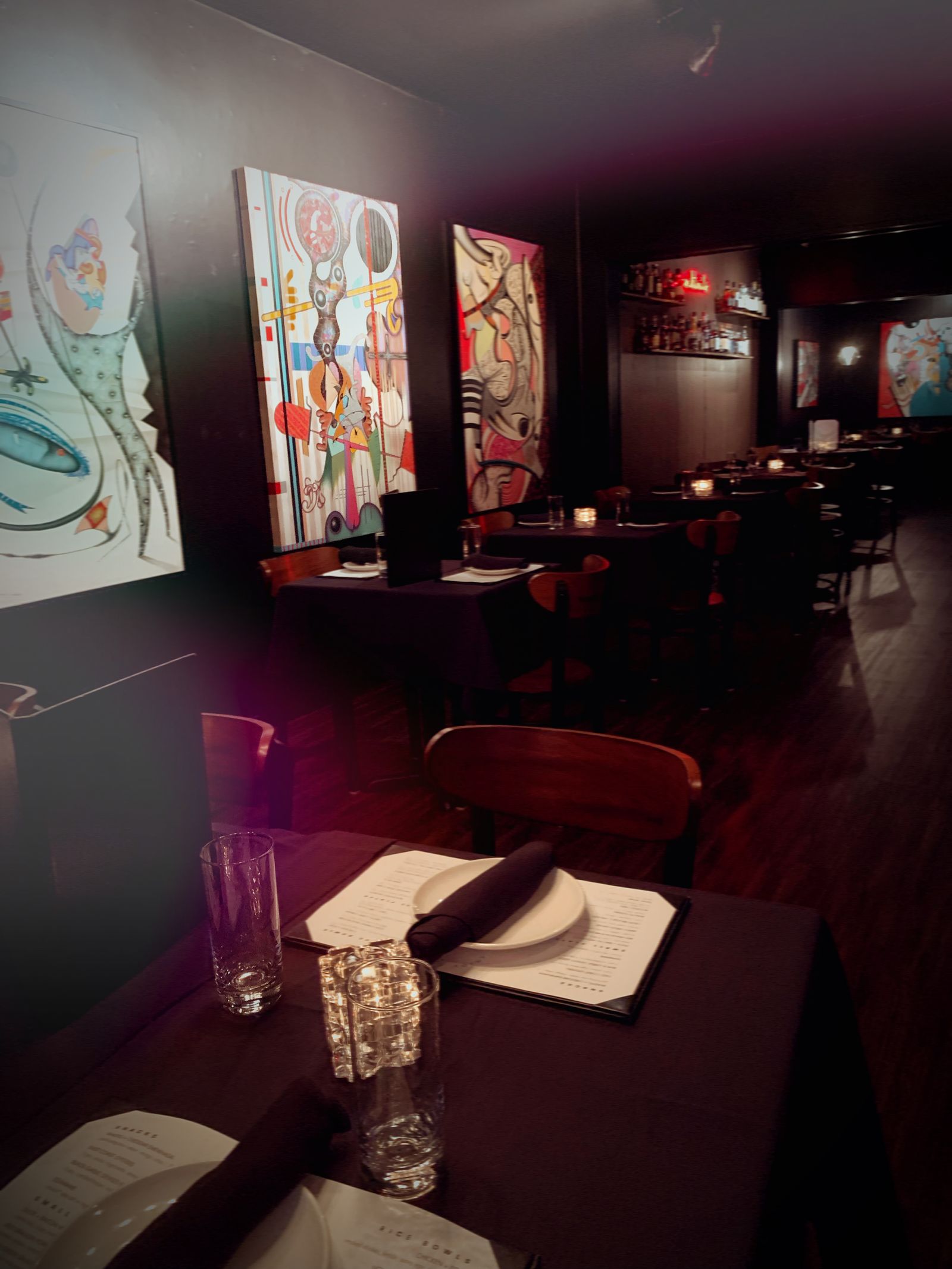 Lucky Duck private dining room with art-lined black walls and candlelit tables